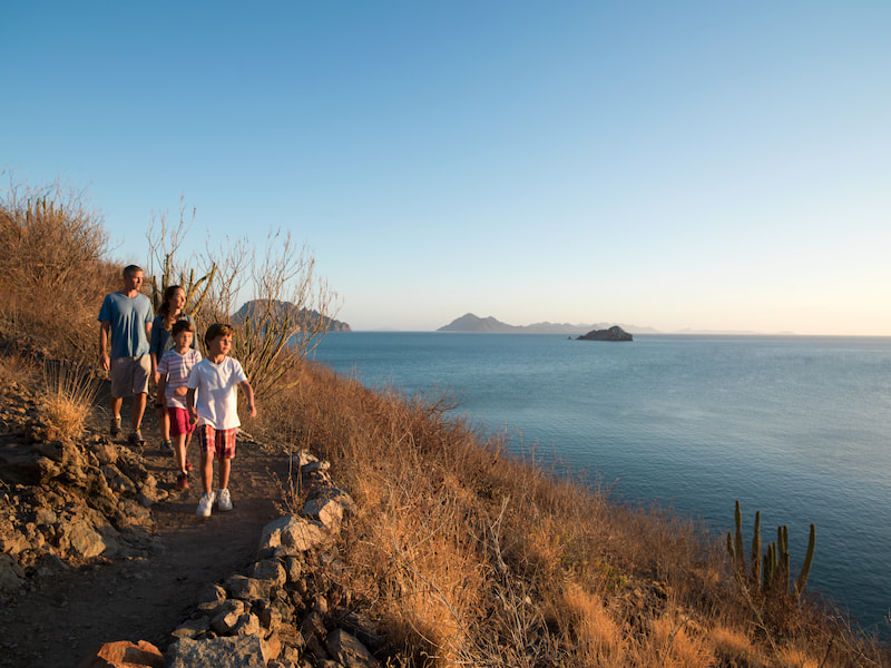 family hiking around villa del palmar loreto resort